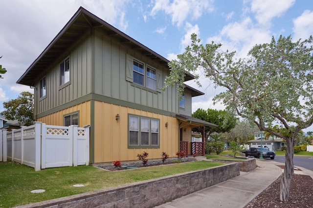 62 Meheu Cir, Kahului, HI 96732 - view of property exterior with a yard, board and batten siding, and fence