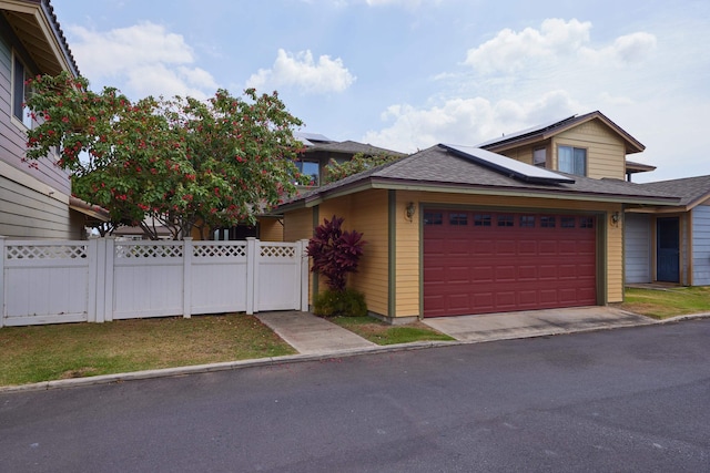 62 Meheu Cir, Kahului, HI 96732 - view of front of property with a gate, an attached garage, fence, and solar panels