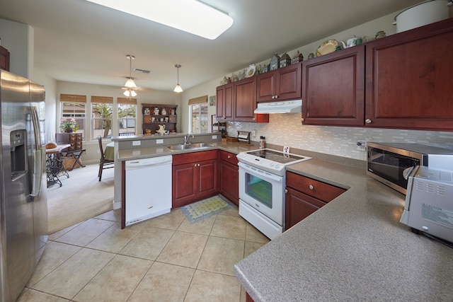 62 Meheu Cir, Kahului, HI 96732 - kitchen featuring tasteful backsplash, a peninsula, under cabinet range hood, a sink, and stainless steel appliances