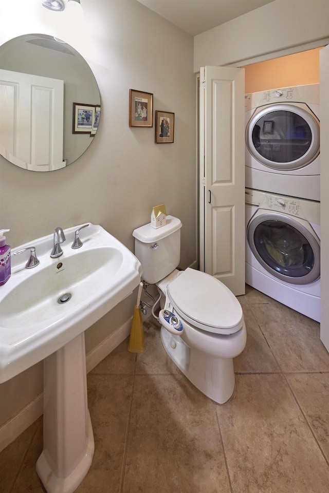 62 Meheu Cir, Kahului, HI 96732 - half bath with baseboards, tile patterned flooring, toilet, stacked washer / dryer, and a sink