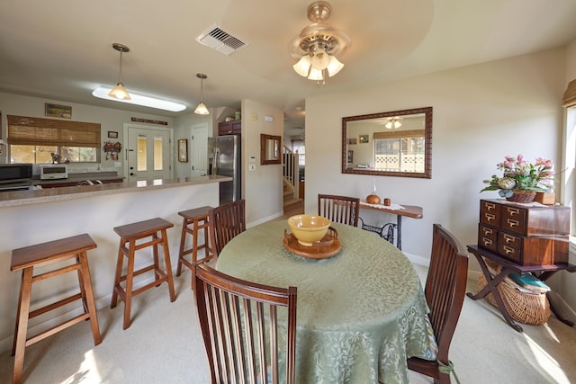 62 Meheu Cir, Kahului, HI 96732 - dining space with visible vents, ceiling fan, light carpet, and stairs