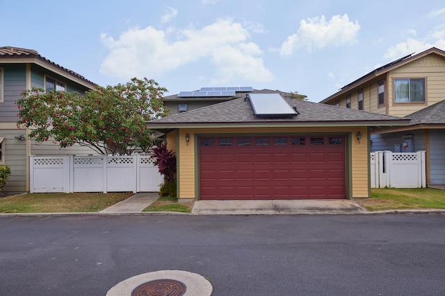 62 Meheu Cir, Kahului, HI 96732 - view of front of property with solar panels, a garage, fence, a gate, and roof with shingles
