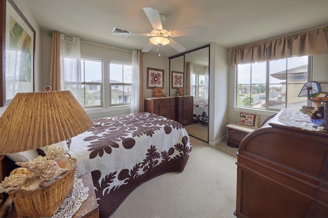 62 Meheu Cir, Kahului, HI 96732 - bedroom with baseboards, a closet, light carpet, a ceiling fan, and visible vents