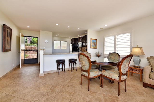 dining space featuring recessed lighting, baseboards, and light tile patterned floors