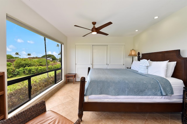 tiled bedroom featuring ceiling fan and multiple windows