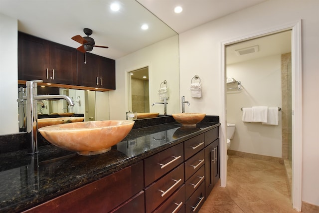 bathroom featuring ceiling fan, double vanity, toilet, and tile patterned flooring