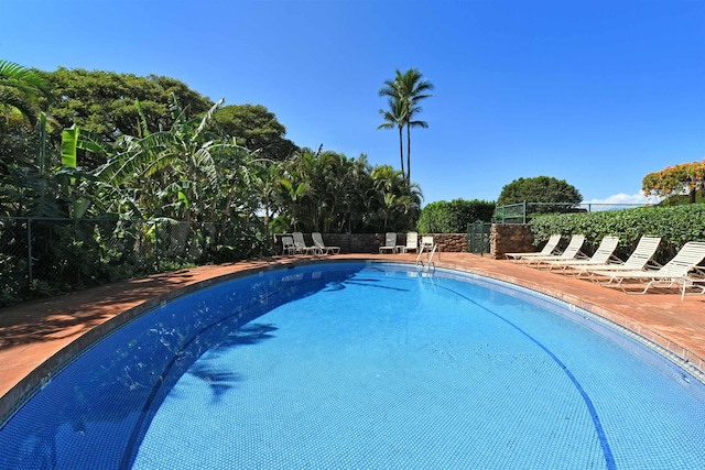 pool with fence and a patio