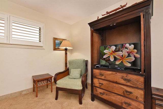 living area featuring baseboards