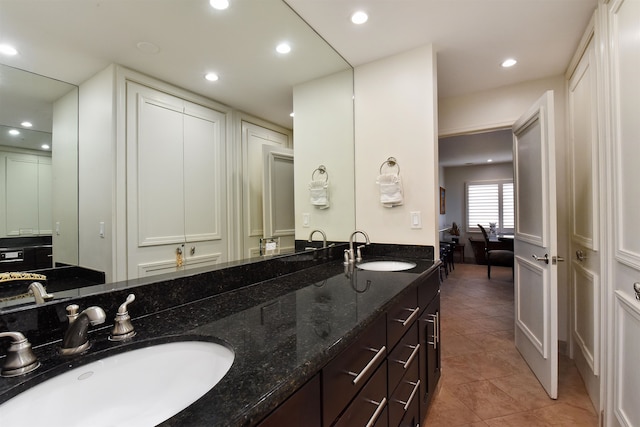 bathroom with dual vanity and tile patterned flooring