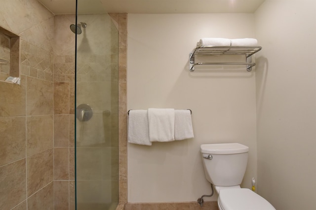 bathroom featuring walk in shower and toilet