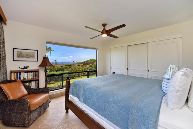 bedroom featuring light tile patterned flooring, a closet, and ceiling fan