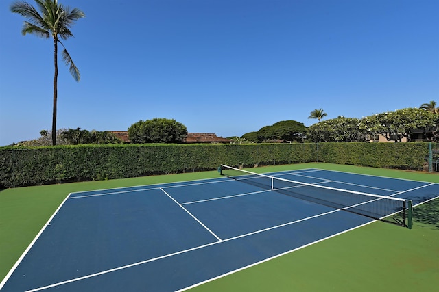 view of tennis court featuring community basketball court and fence