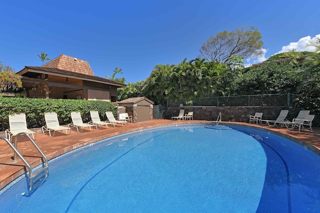 view of swimming pool with an outbuilding