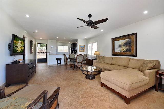 tiled living room featuring ceiling fan and a wealth of natural light