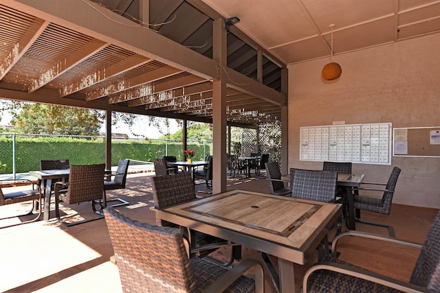 view of patio featuring outdoor dining space and fence