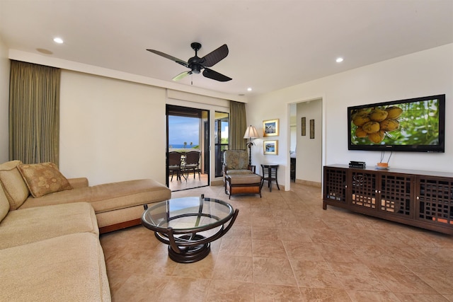 living room featuring baseboards, a ceiling fan, and recessed lighting