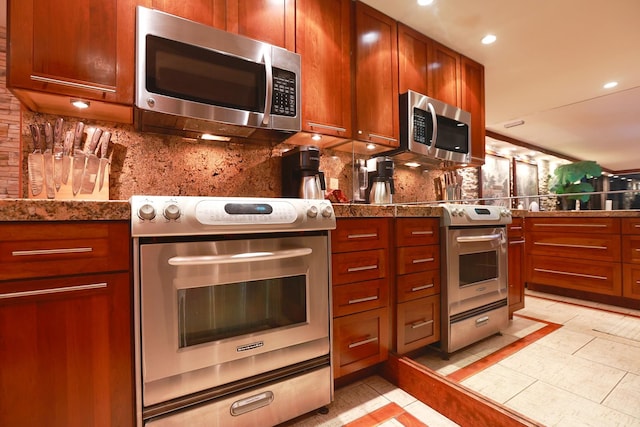 kitchen with light tile patterned floors, tasteful backsplash, and appliances with stainless steel finishes