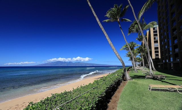 view of water feature with a mountain view and a beach view