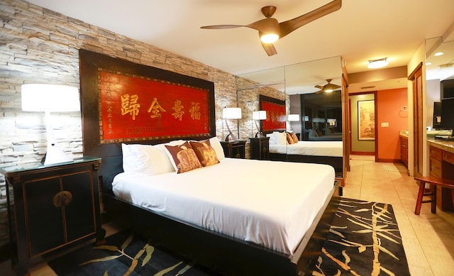 tiled bedroom featuring ceiling fan