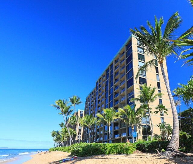 view of property featuring a view of the beach and a water view