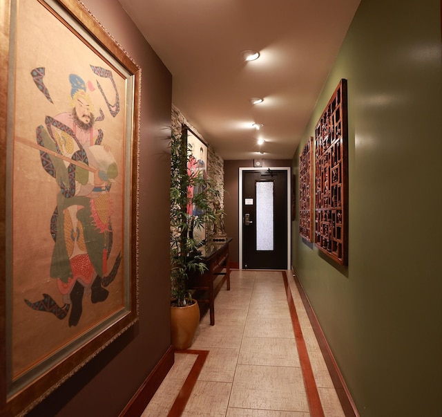 hall with light tile patterned floors