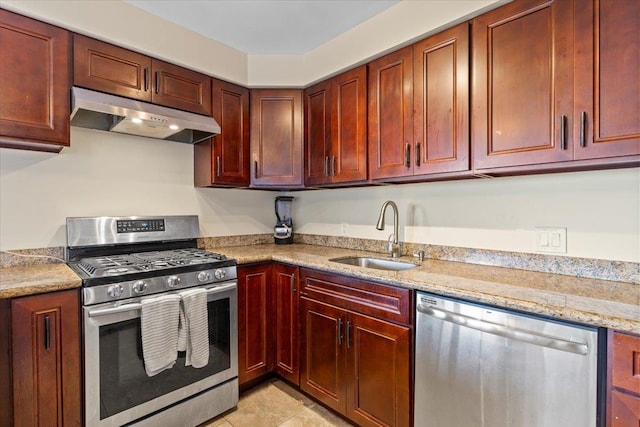 kitchen with light stone counters, appliances with stainless steel finishes, light tile patterned floors, and sink