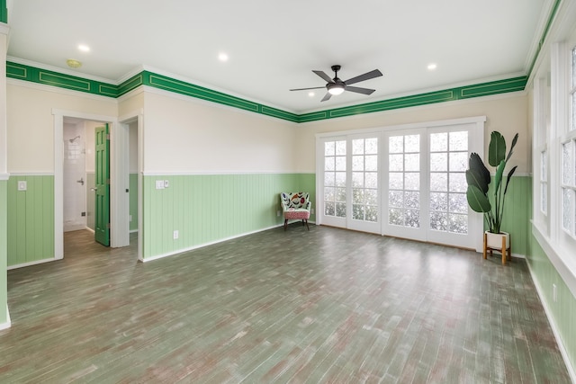 unfurnished room featuring ceiling fan, ornamental molding, and hardwood / wood-style flooring