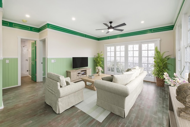 living room featuring ceiling fan, crown molding, and dark wood-type flooring