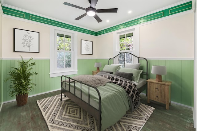 bedroom with ceiling fan, ornamental molding, and dark wood-type flooring