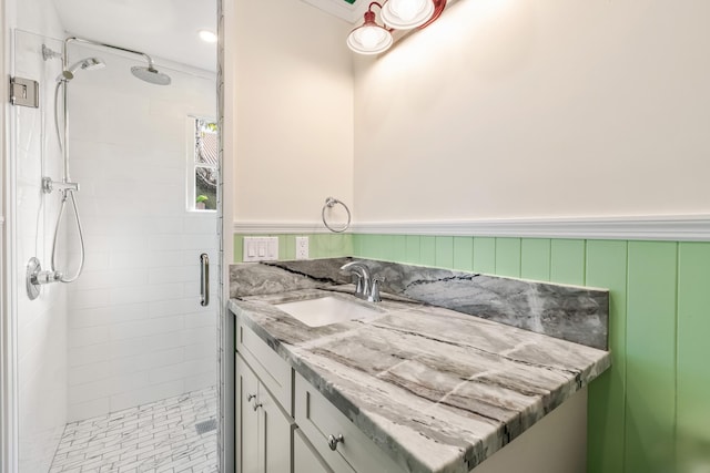 bathroom with vanity and a shower with shower door