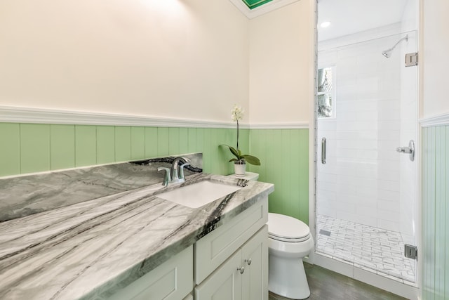 bathroom featuring toilet, hardwood / wood-style floors, vanity, and walk in shower