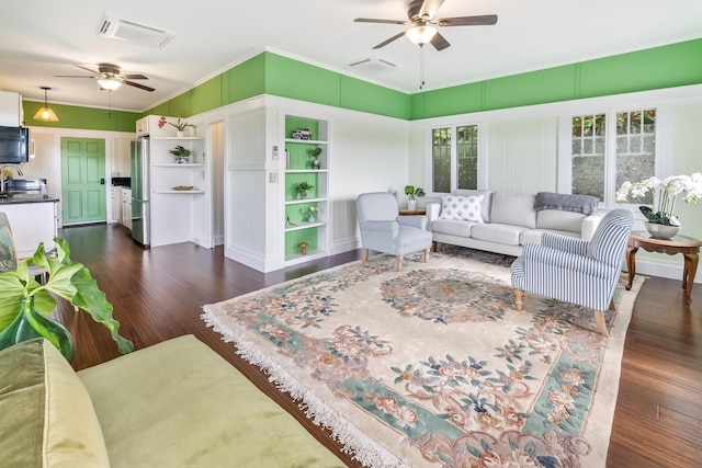 living room featuring dark hardwood / wood-style floors, ceiling fan, and ornamental molding