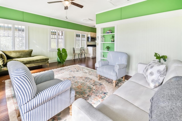 living room featuring ceiling fan, built in features, and dark wood-type flooring