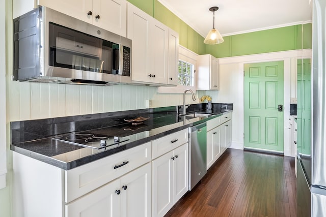 kitchen with sink, white cabinetry, dark wood-type flooring, and appliances with stainless steel finishes