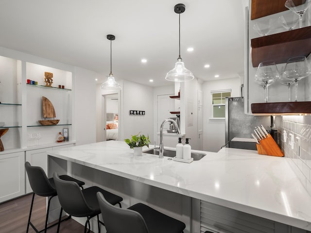 3950 Kalai Waa St Unit C202, Kihei, HI 96753 - kitchen featuring open shelves, a peninsula, white cabinets, tasteful backsplash, and light stone countertops