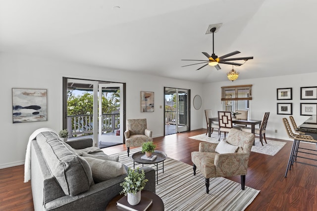 living area with ceiling fan, baseboards, wood finished floors, and vaulted ceiling