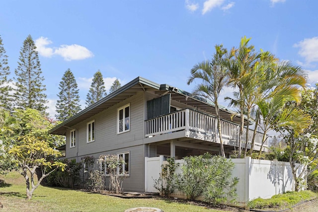 view of property exterior featuring a yard and fence