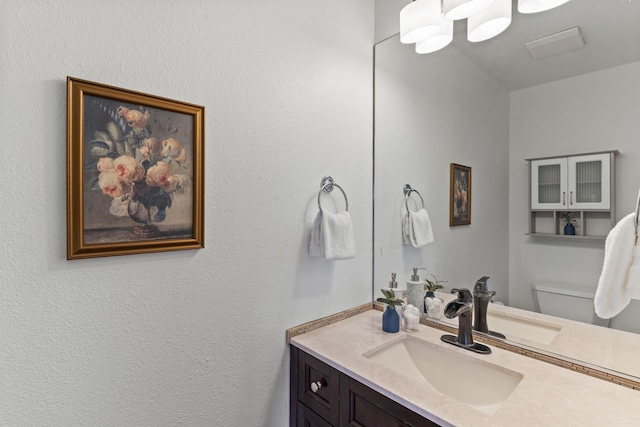 bathroom featuring toilet and vanity