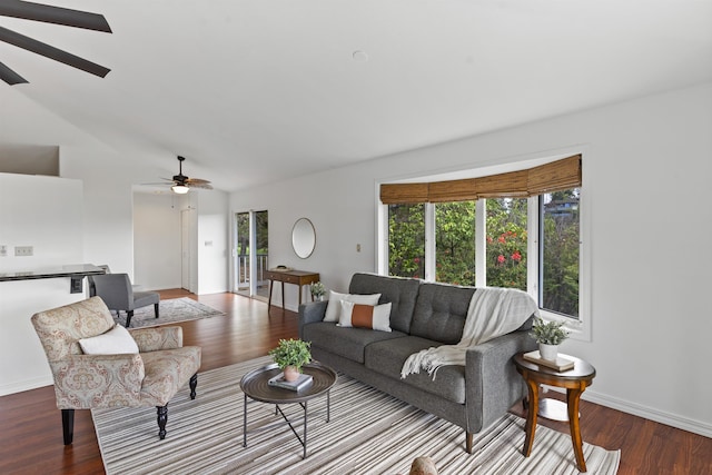 living room with baseboards, wood finished floors, and a ceiling fan