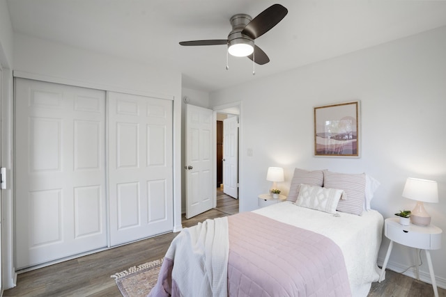 bedroom featuring a closet, baseboards, a ceiling fan, and wood finished floors