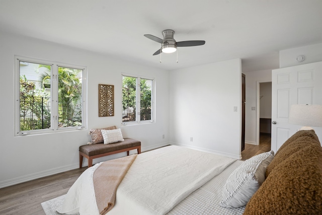 bedroom featuring ceiling fan, baseboards, and wood finished floors