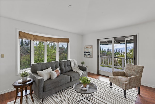 living area featuring baseboards and wood finished floors