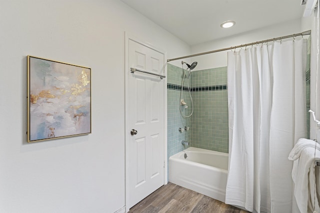 bathroom featuring shower / bath combo and wood finished floors