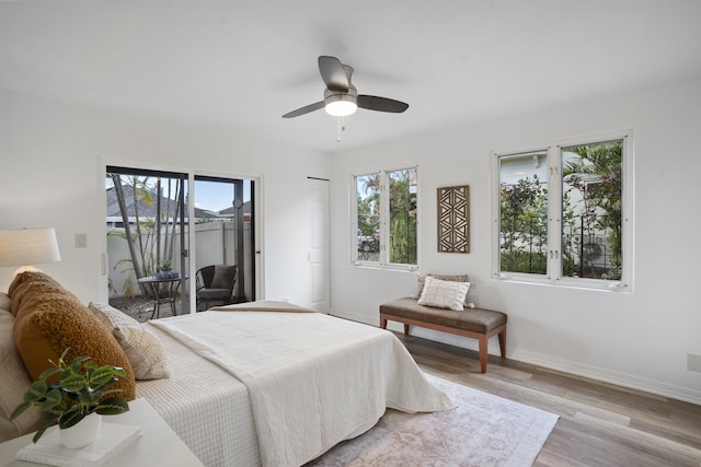 bedroom with baseboards, wood finished floors, access to exterior, and a ceiling fan