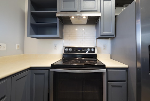 kitchen featuring stainless steel fridge with ice dispenser, black electric range oven, ventilation hood, and gray cabinetry