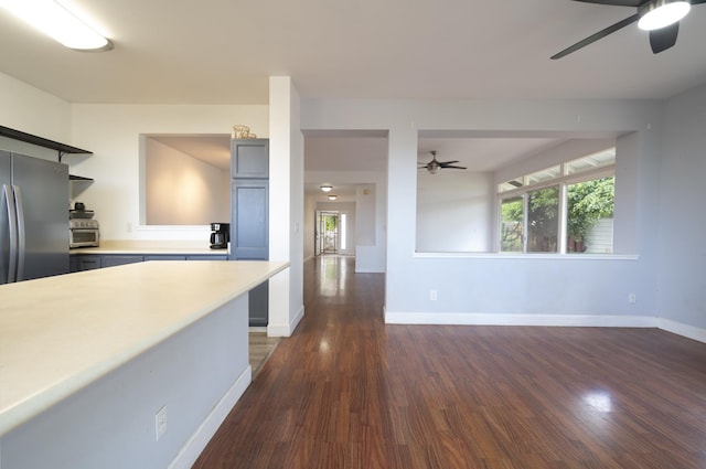 kitchen featuring dark wood-type flooring, stainless steel refrigerator, and ceiling fan