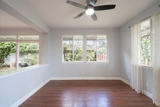 unfurnished room with ceiling fan, dark hardwood / wood-style flooring, and a wealth of natural light