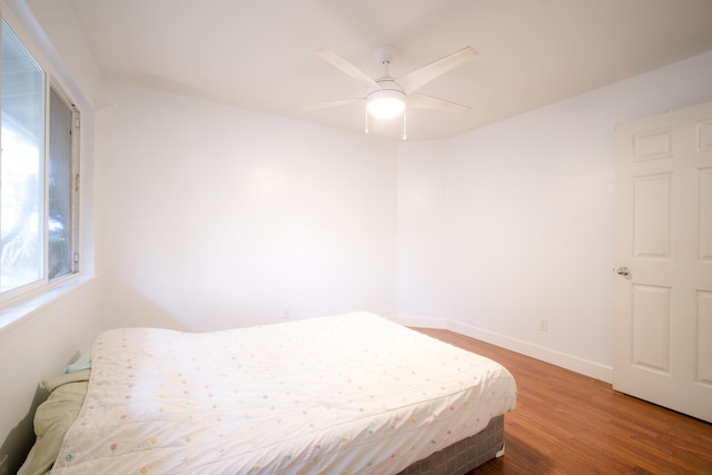 bedroom featuring wood-type flooring and ceiling fan