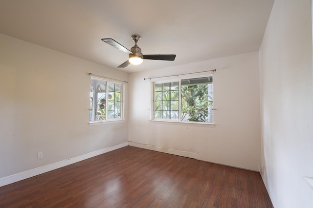 unfurnished room featuring dark wood-type flooring and ceiling fan