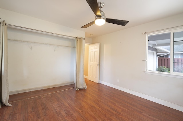 unfurnished bedroom featuring ceiling fan, dark hardwood / wood-style flooring, and a closet